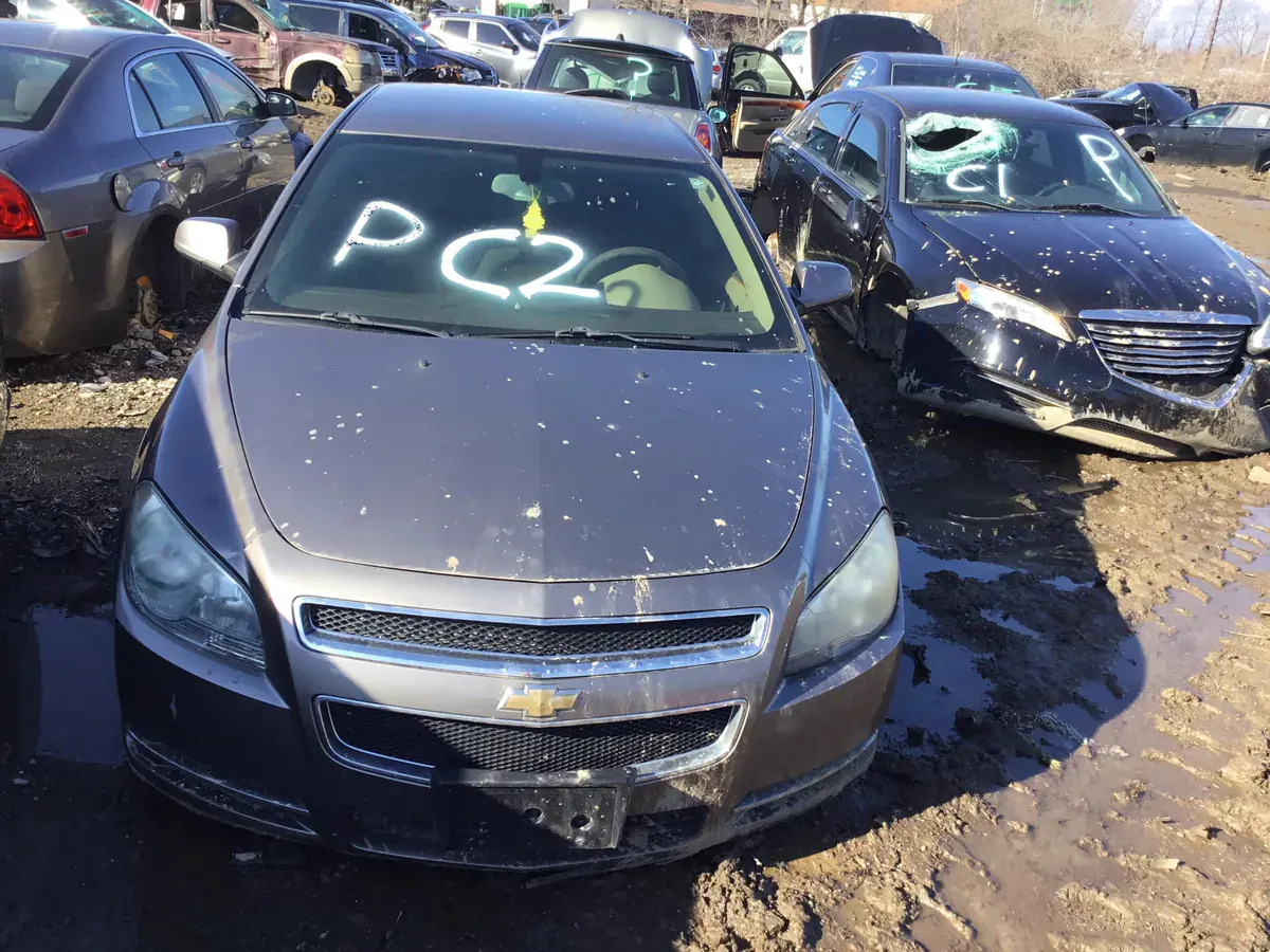 Vehicles staged at The New Country Auto Parts salvage yard in Indianapolis, ready for parts processing
