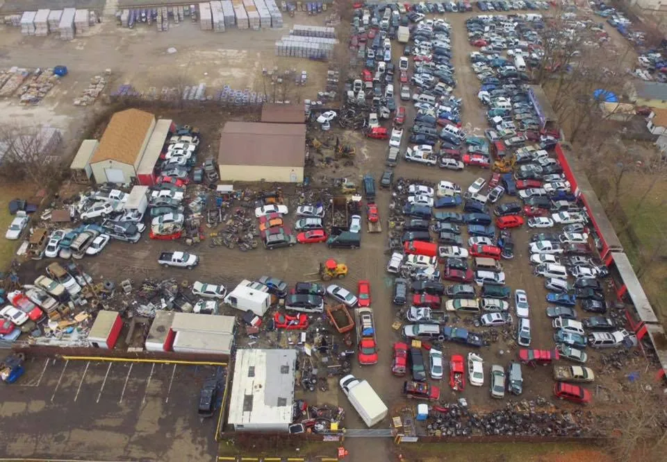Rows of used cars and trucks organized across a full-service Indianapolis salvage yard lot